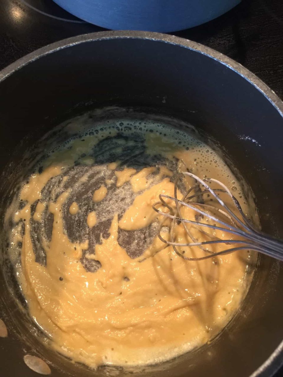 Picture of flour, butter and mustard powder paste in a saucepan post mix for Buffalo Chicken Mac & Cheese
