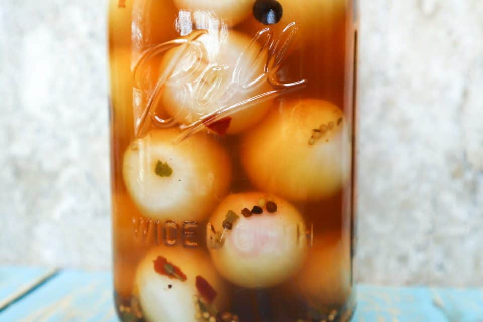 Picture of finished pickled onions in a sealed jar.