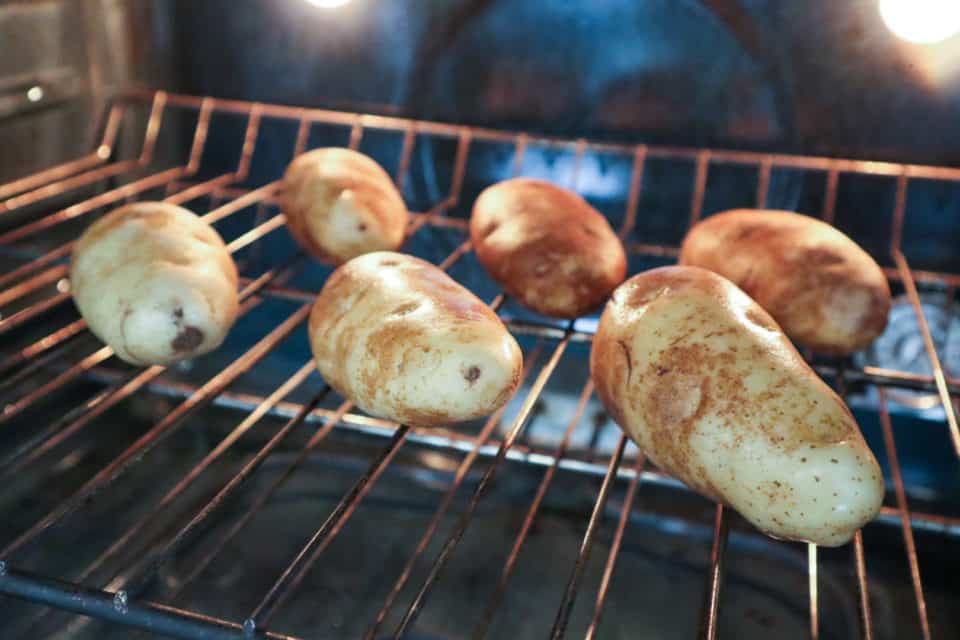 Potatoes on the rack in the oven, prebaking.
