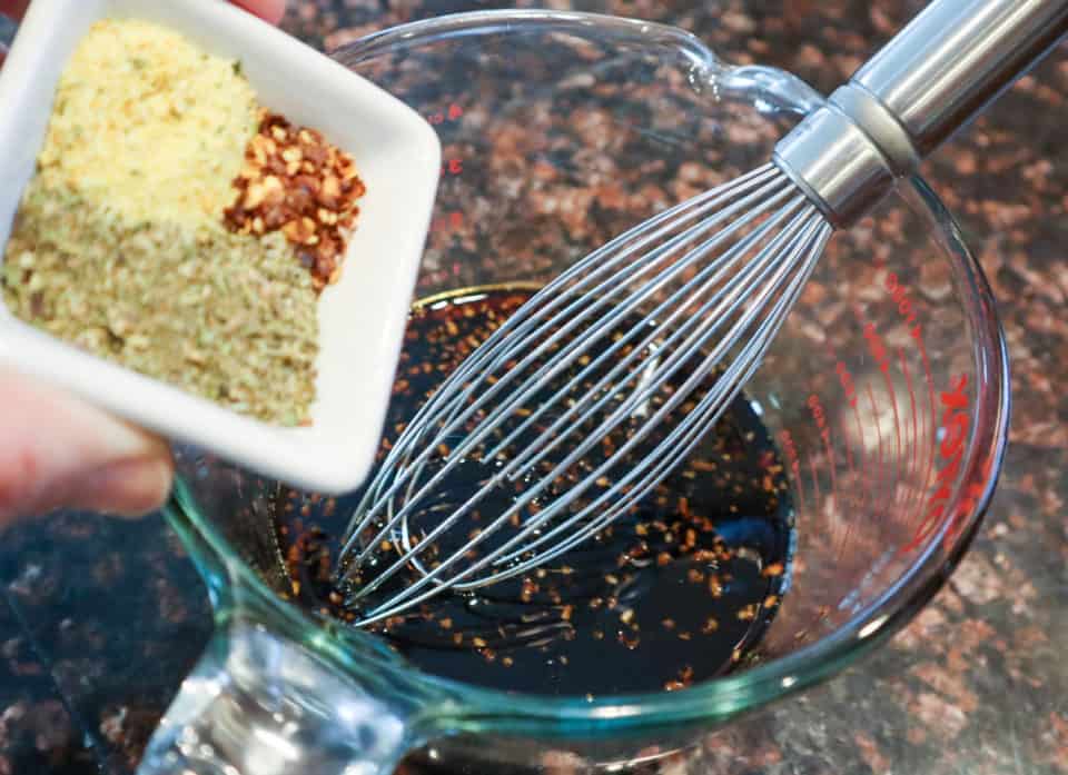 Seasonings for Honey Garlic Sauce being whisked into a measuring cup.