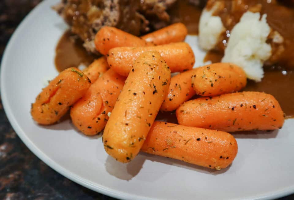 Finished Air Fryer Roasted Baby Carrots on a plate.