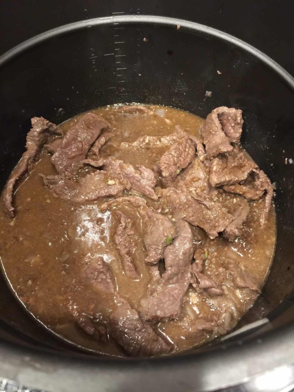 Beef broth mixture added to instant pot with beef slices for Instant Pot Beef with Broccoli