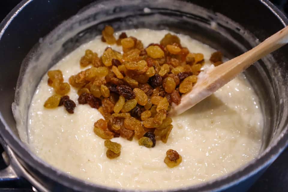 Mixing raisins into rice and egg mixture for Classic Rice Pudding