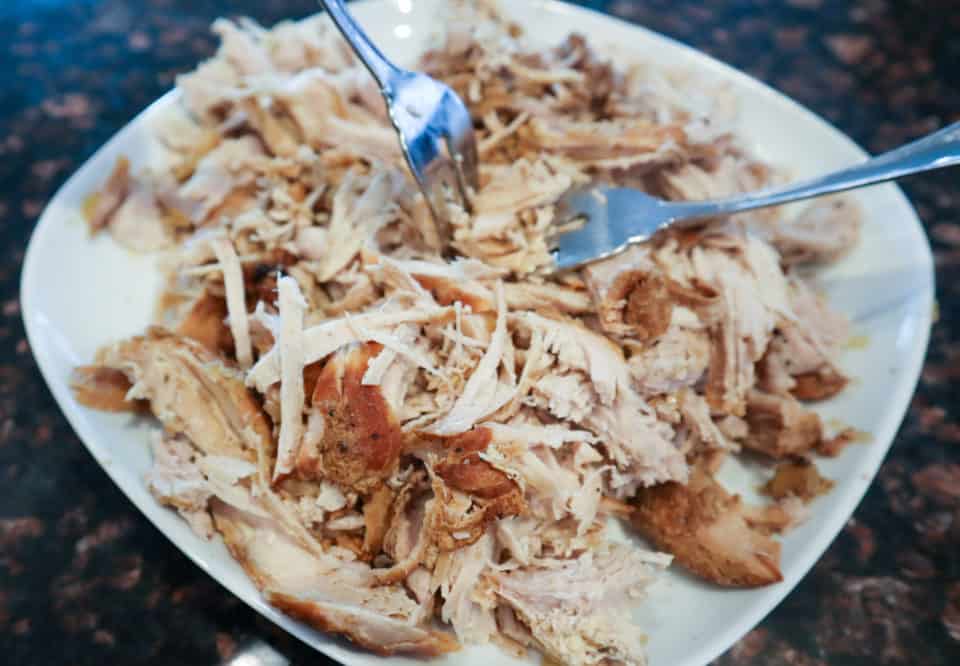 Picture of shredded pulled pork with forks on a plate.