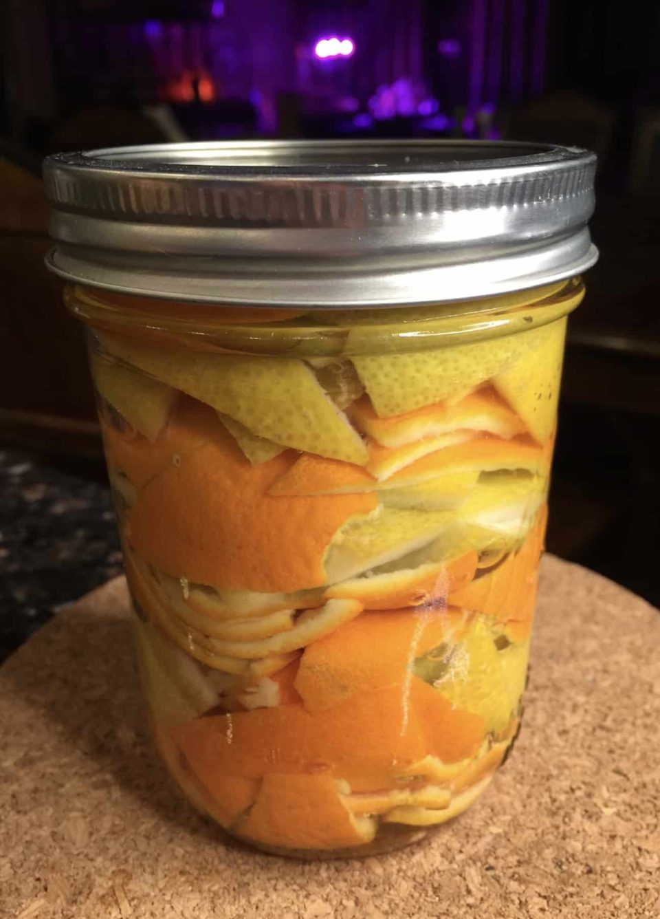 Citrus peels and vinegar sealed tightly in a jar.