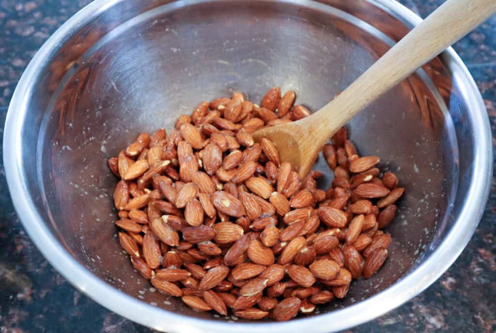 Stirring the almonds in the frothy egg and vanilla mixture.