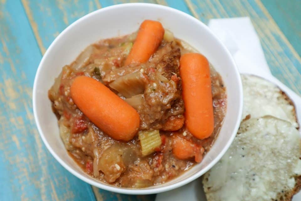 Picture of Hearty Slow Cooker Beef Stew ready to eat in a bowl with a side of bread