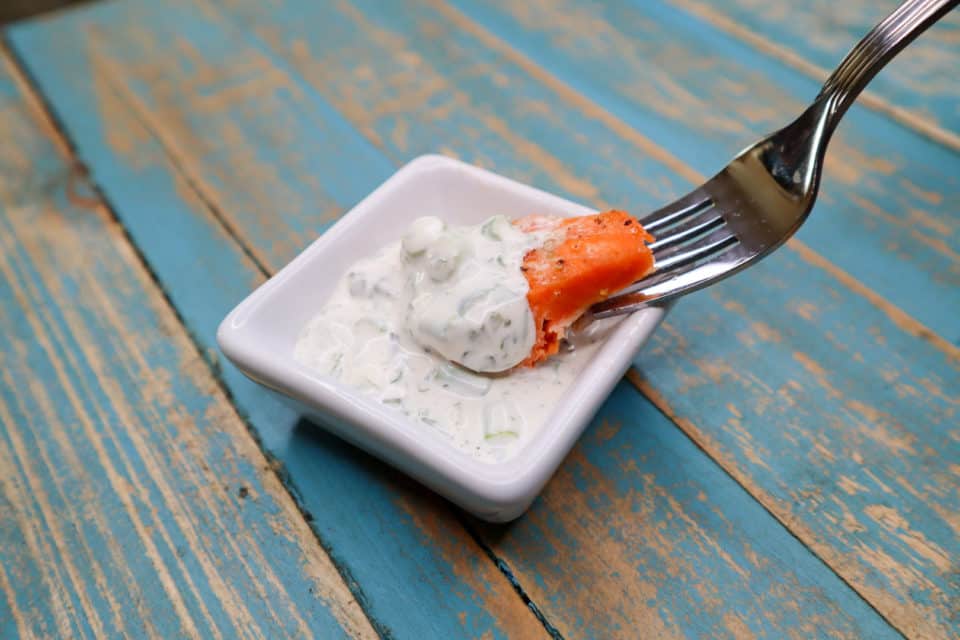 Picture of finished Simple Baked Salmon with Green Goddess Sauce on a fork.