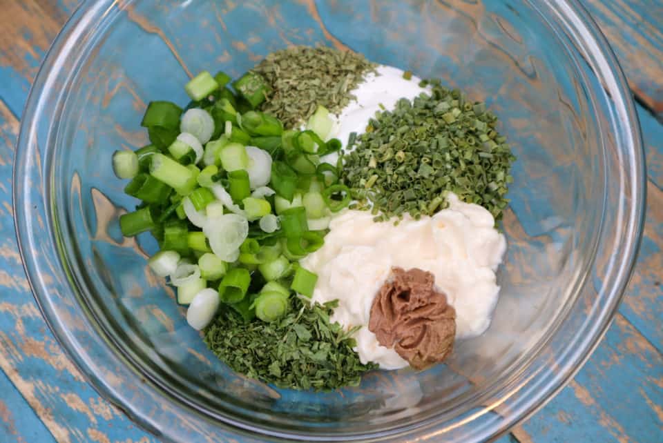 Picture of ingredients for Green Goddess Sauce in a bowl before mixing.