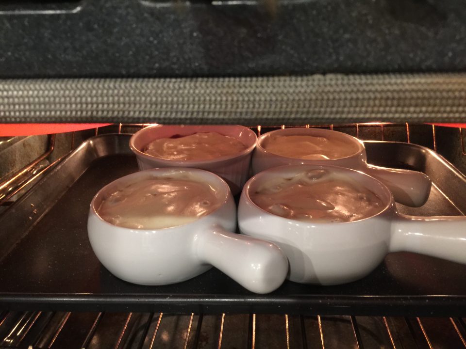 Soup bowls on a baking sheet under the broiler for Crock Pot French Onion Soup.