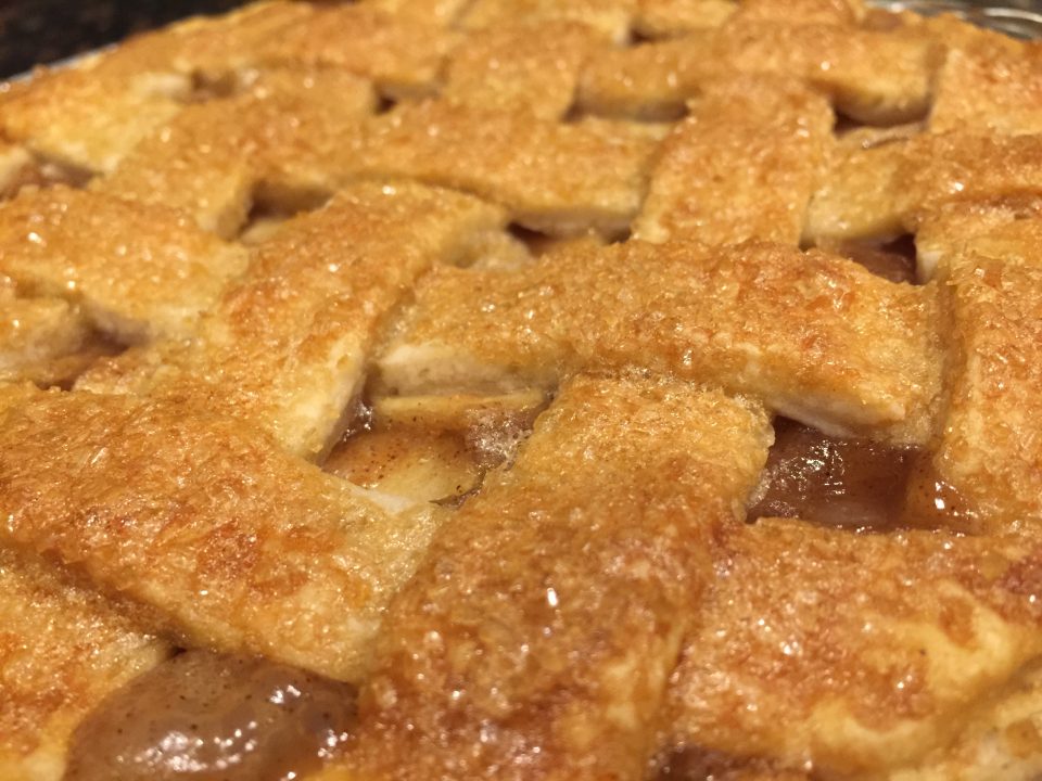Up close picture of golden brown pie crust for Caramel Apple Pie/