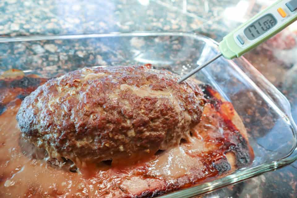Finished Simple Weeknight Meatloaf in a baking dish with a thermometer reading 171 degrees F.