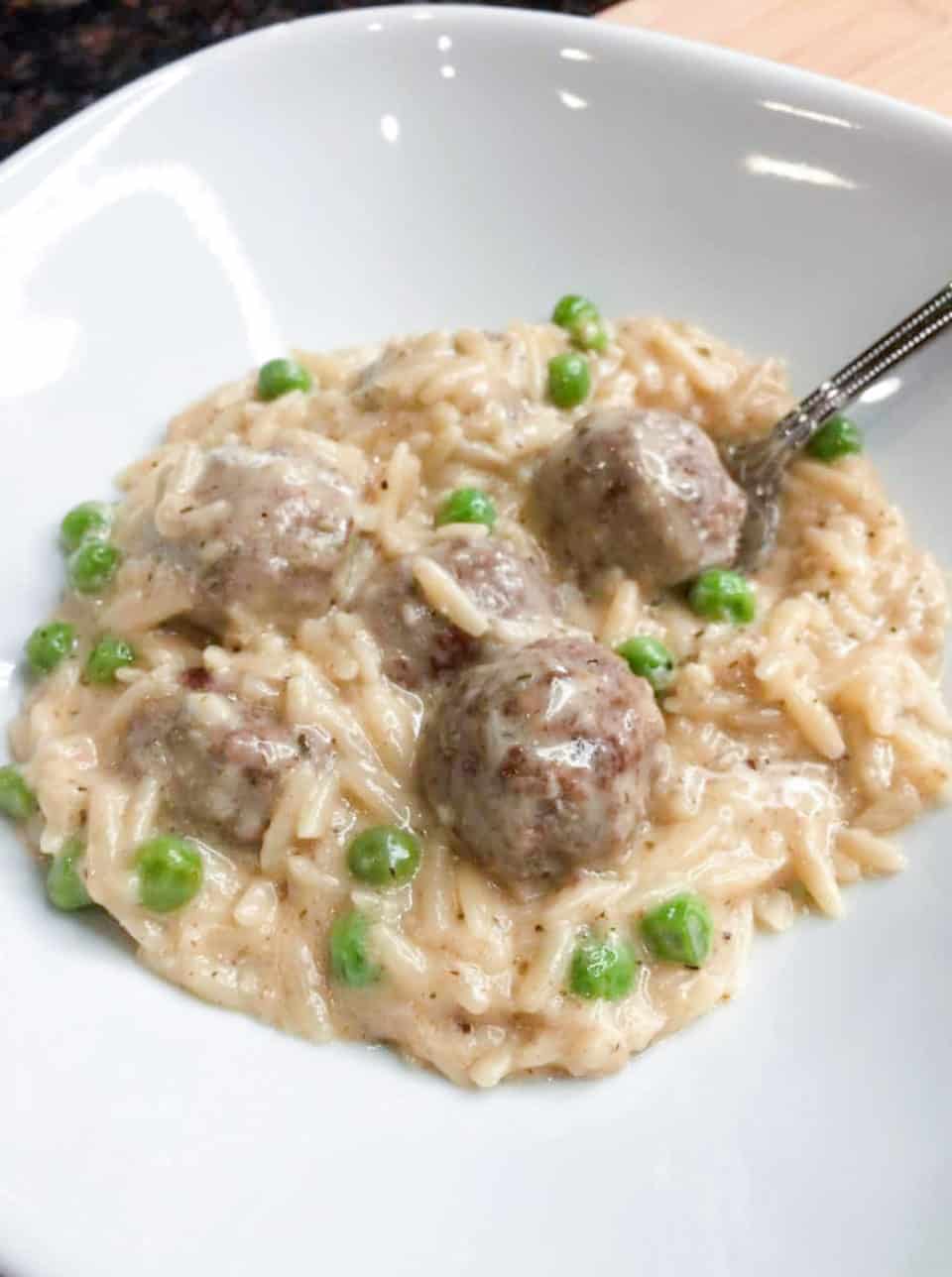 Finished picture of Creamy Orzo with Meatballs and Peas in a bowl.