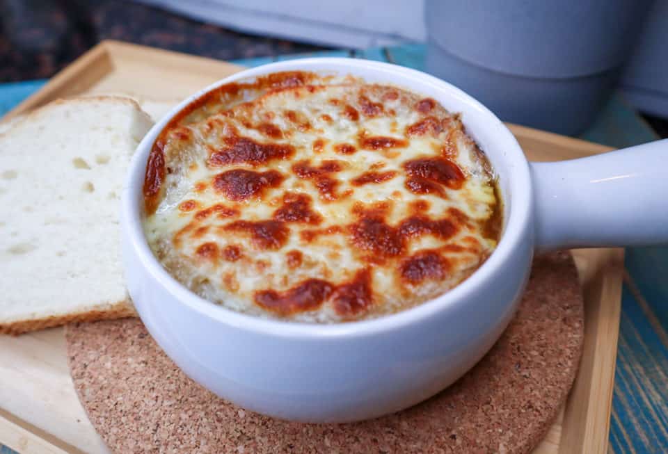 Finished photo of Crock Pot French Onion Soup in a bowl with broiled cheese.