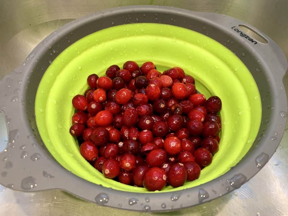 Cranberries after being rinsed in a colander.