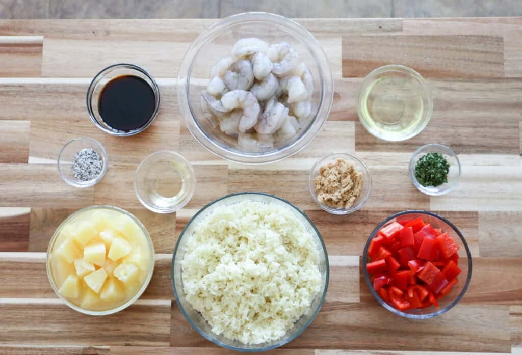Ingredients for Pineapple Shrimp and Rice Bake on a board.