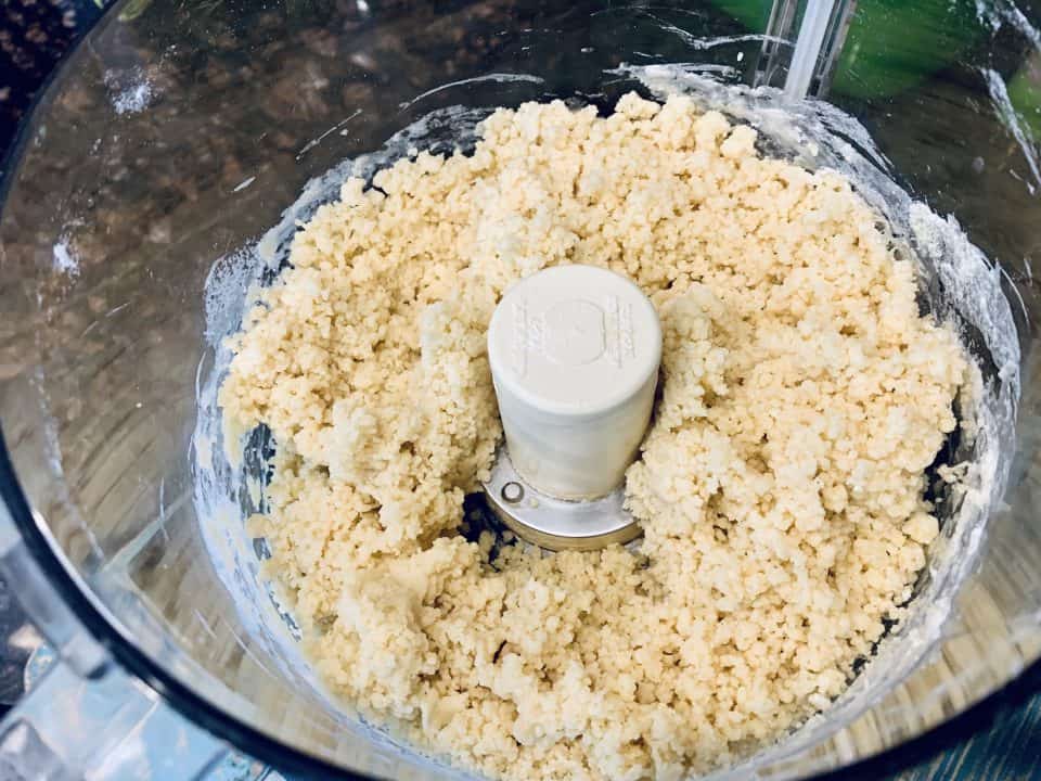 Crumbly Fresh Homemade Pasta dough in a food processor.
