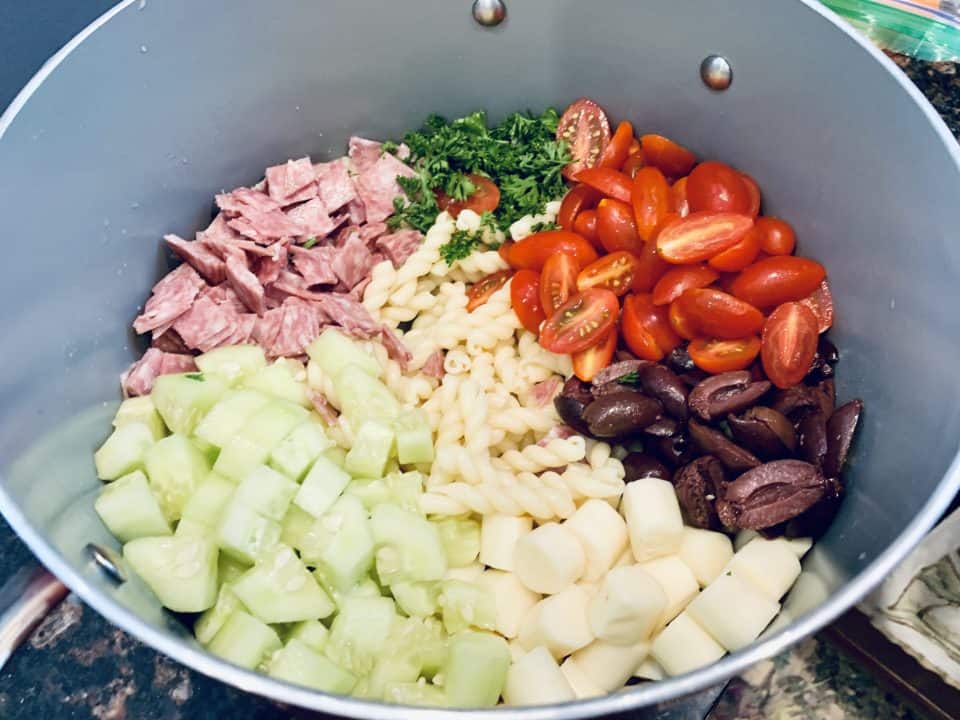 Picture of perfect potluck pasta salad ingredients in a bowl prior to being mixed