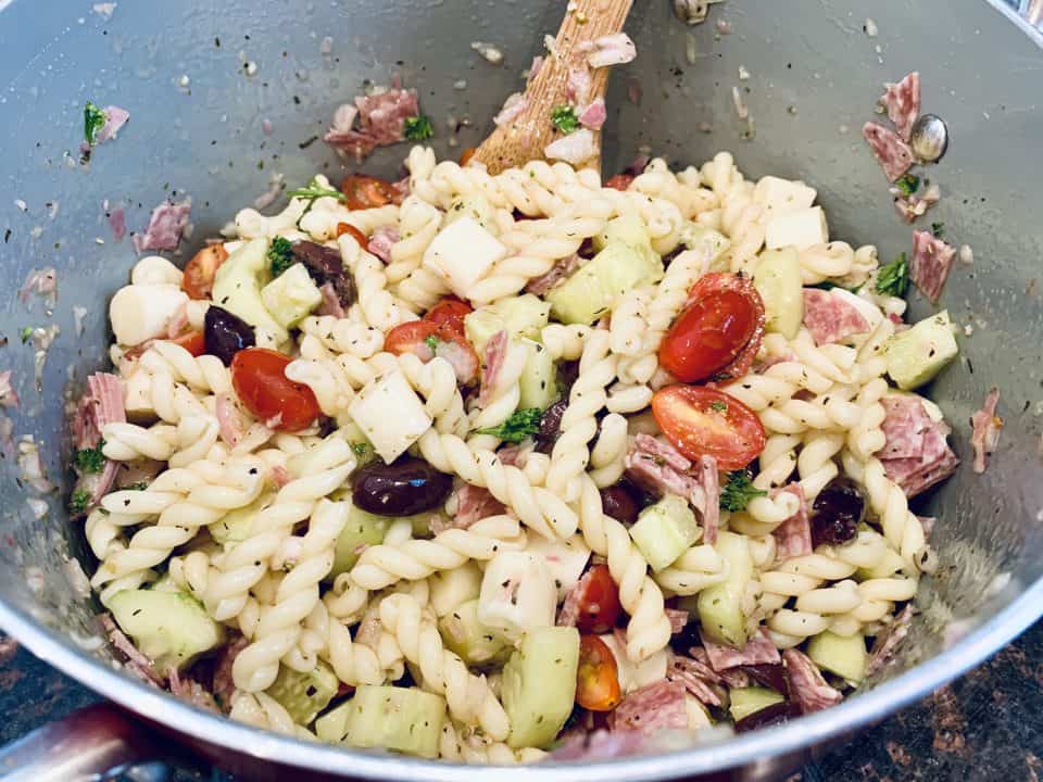 Picture of perfect potluck pasta salad ingredients in a bowl just after being mixed