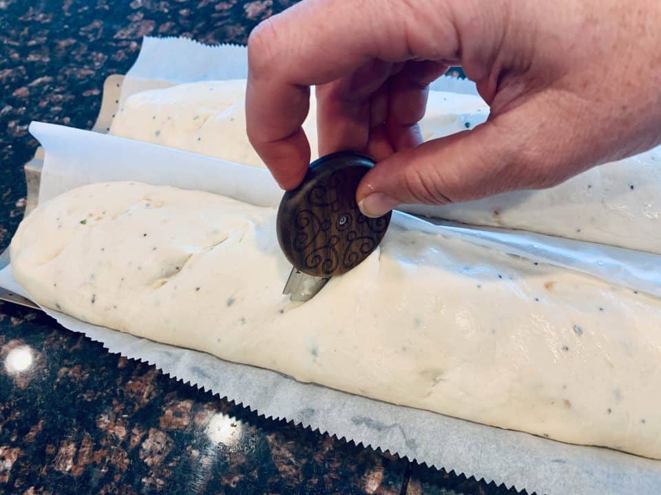 Picture of the dough being scored with a knife