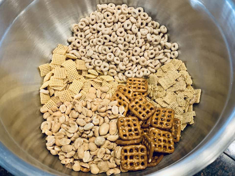 Dry ingredients for Savory Chex Mix in a bowl.