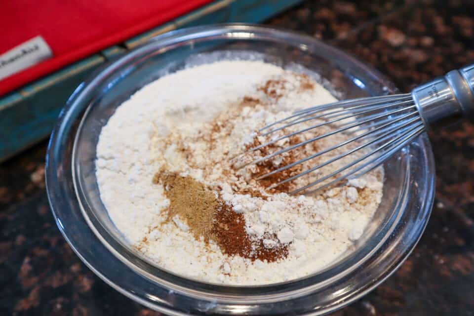 Dry ingredients for Small Batch Gingerbread Friends with a whisk.