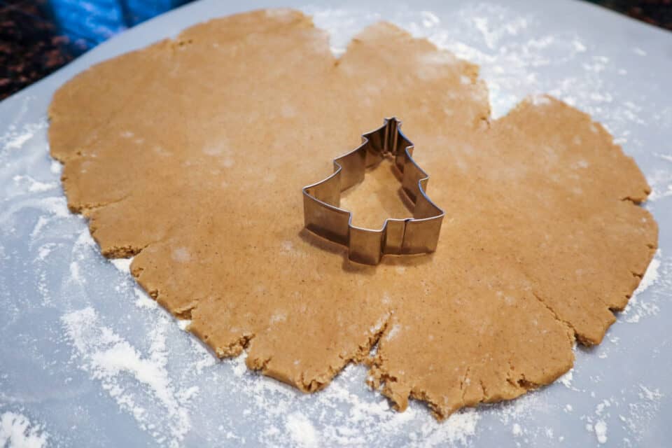 Rolling out the dough and cutting out the Small Batch Gingerbread Friends in different shapes.