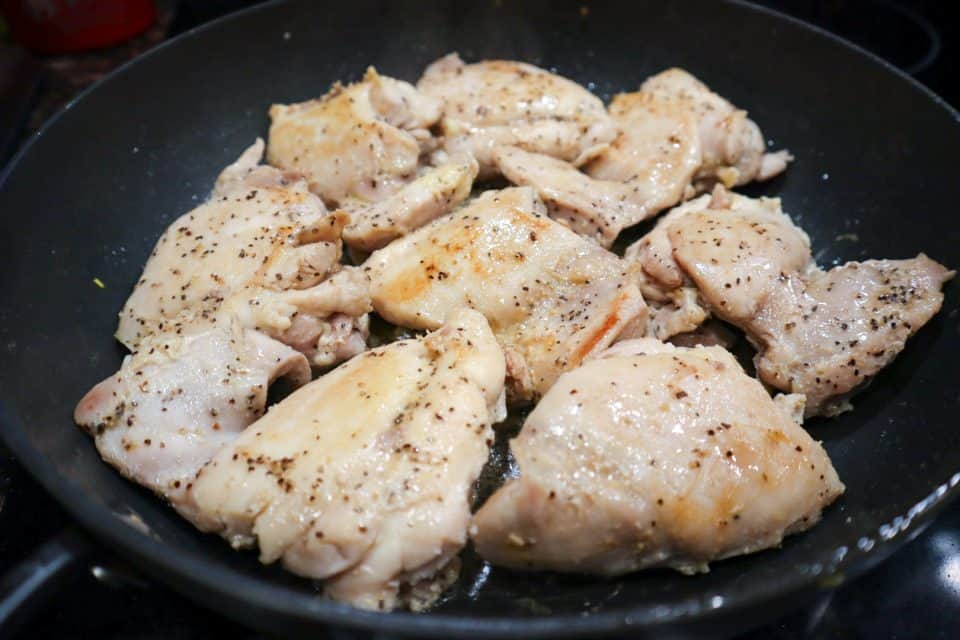 Picture of browned chicken thighs in the skillet