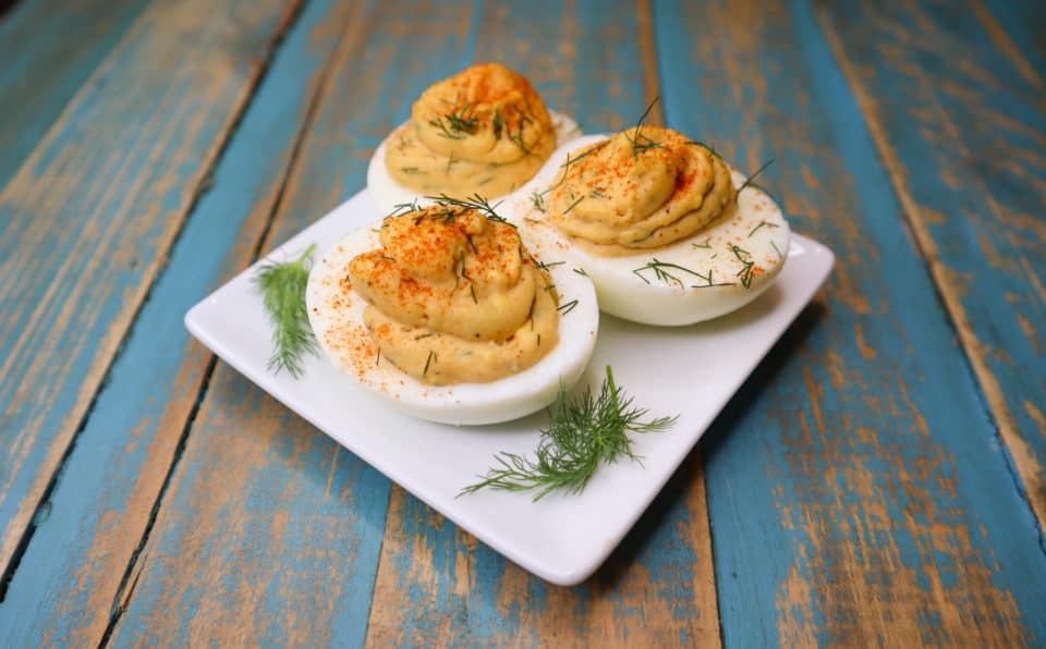 Finished Spicy Deviled Eggs up close on a plate.