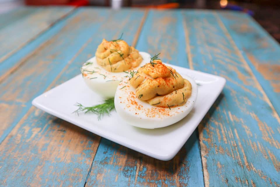 Finished Spicy Deviled Eggs up close on a plate.