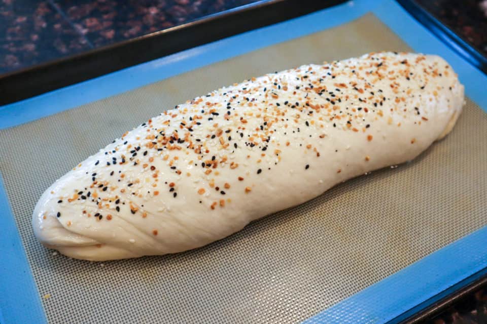 Picture of Everyday French Bread loaf with everything bagel seasoning sprinkled on top pre-bake