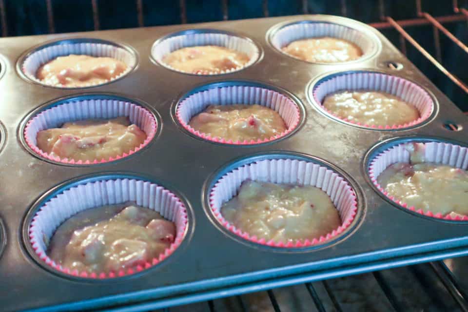 Picture of batter in muffin tin in oven prior to baking Strawberry Banana Oat Bran Muffins