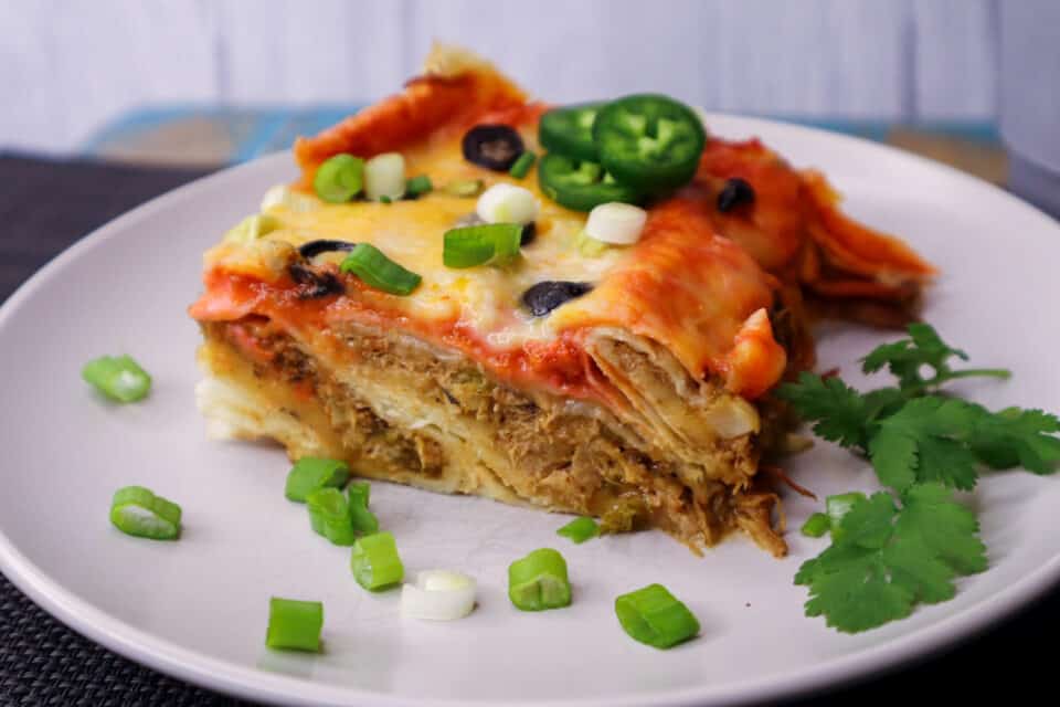 Finished piece of Easy Baked Enchiladas showing layers on a plate