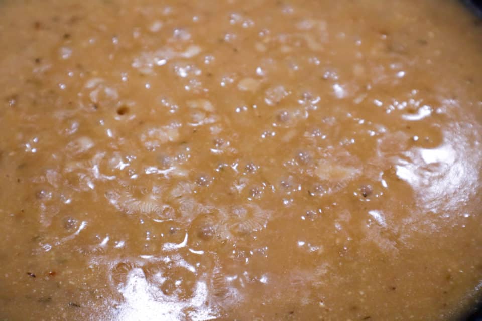 Close up picture of bubbling pan sauce for Easy Pork Chops with Pan Sauce.