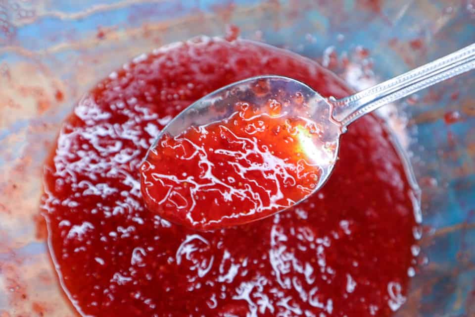Picture of Simple Microwave Strawberry Jam after 10 minutes in the microwave, thickened on a spoon. 