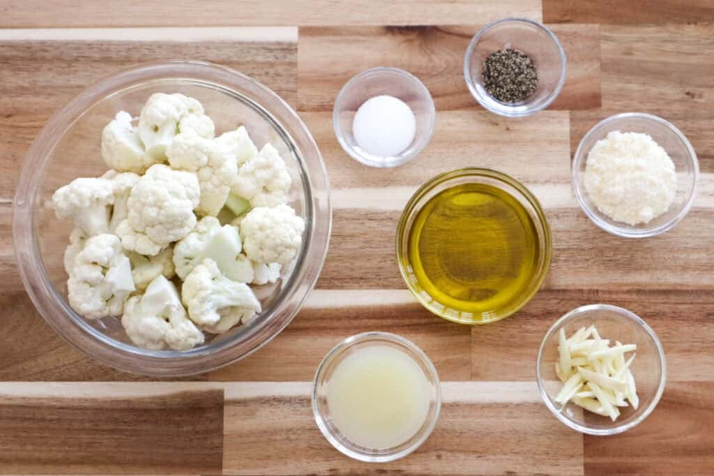 Ingredients for Oven Roasted Cauliflower on a board. 