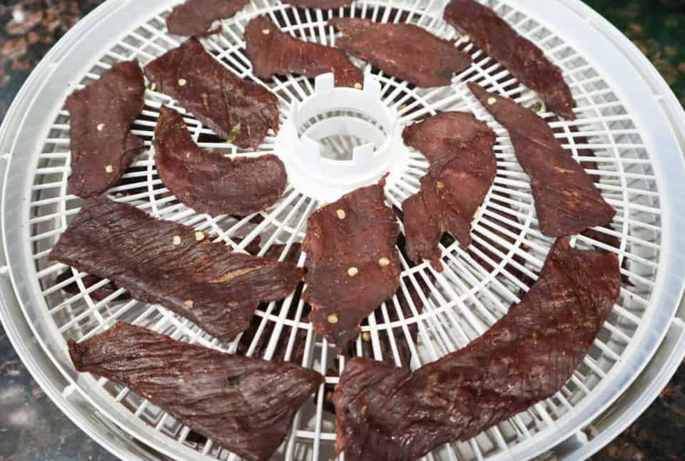 Picture of Spicy Dr. Pepper Beef Jerky on a dehydrator tray after dehydrating.
