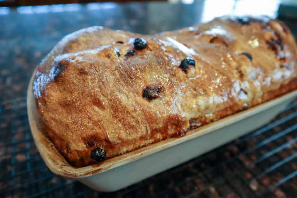 Picture of finished Cinnamon Raisin Sourdough Bread in a loaf pan.