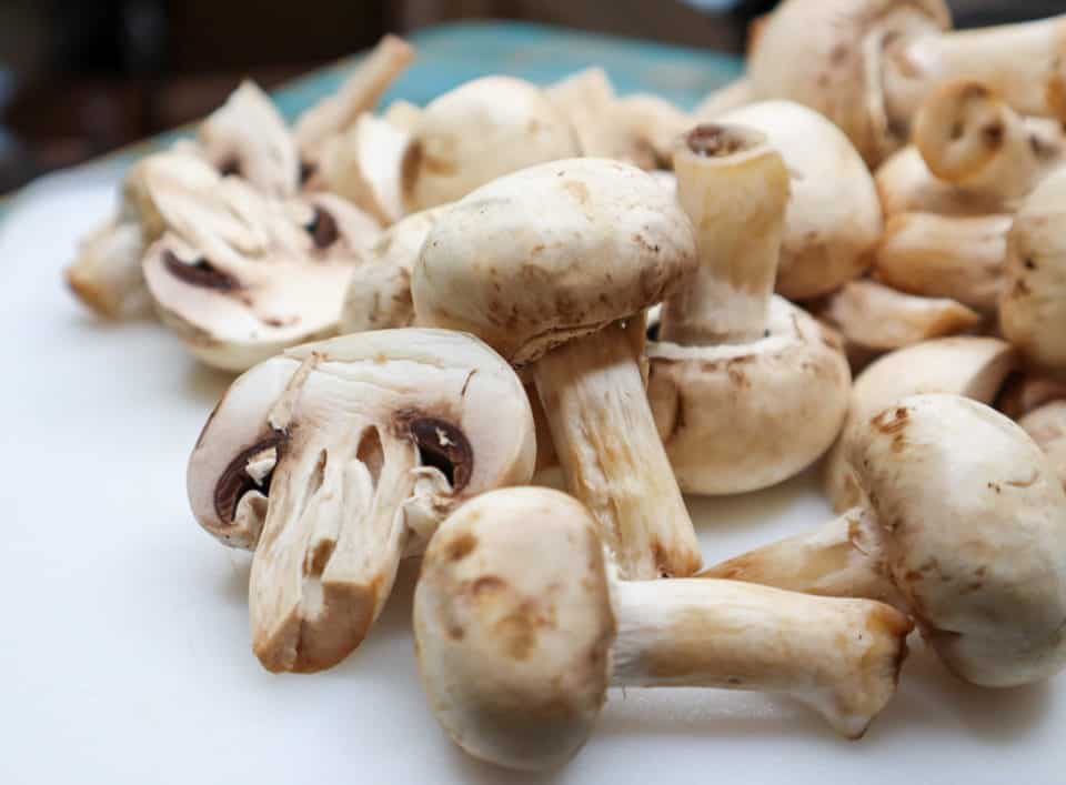 Close up picture of fresh washed mushrooms for Easy Italian Pickled Mushrooms.