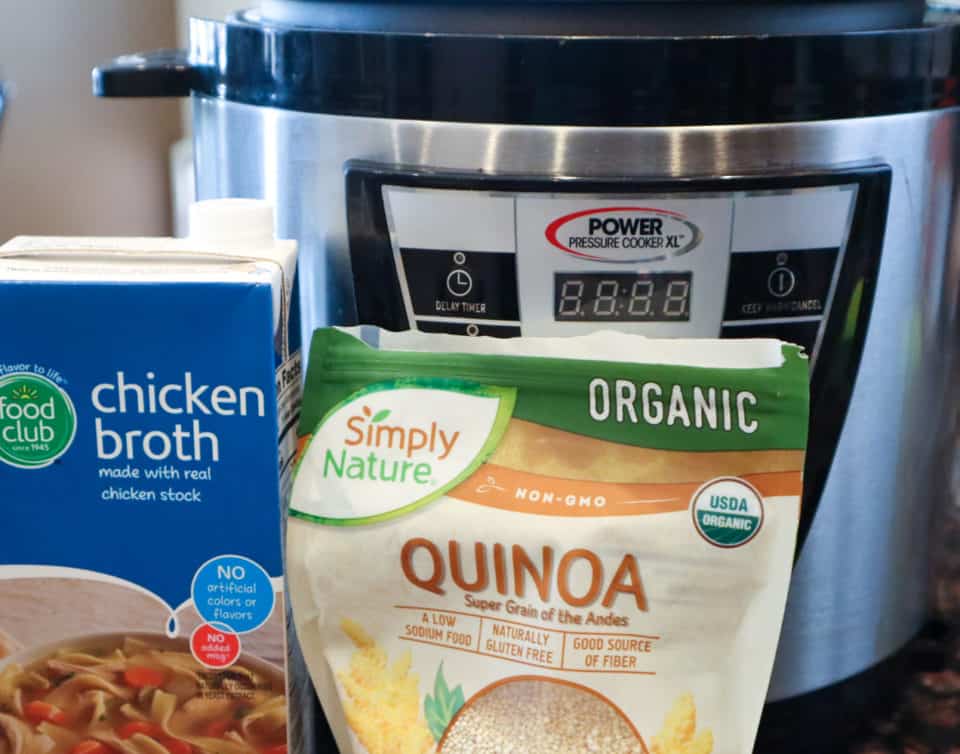 Picture of Instant Pot, Packaged quinoa and packaged chicken broth for Easy Instant Pot Quinoa.