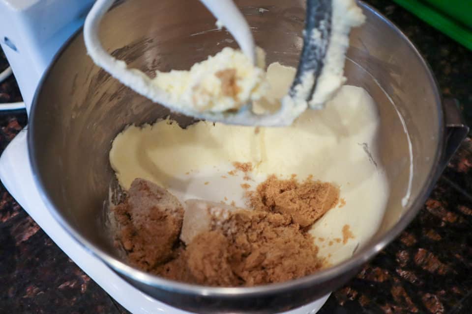 Picture of butter and brown sugar and white sugar in a mixing bowl with a paddle attachment.