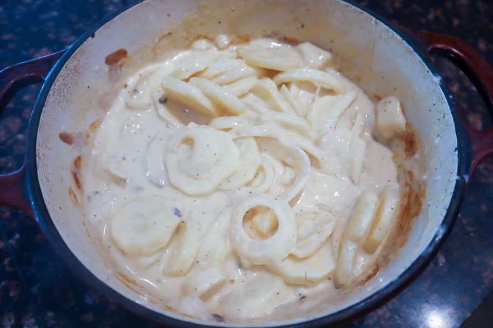 Picture of Throwback Scalloped Potatoes in a dutch oven partway through cooking time.