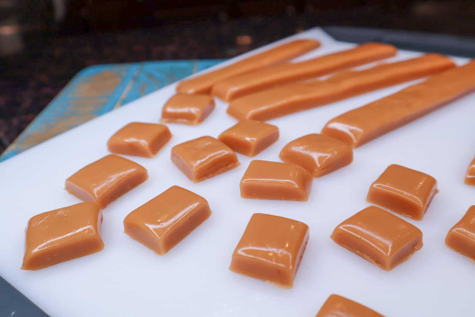 Finished Homemade Soft Caramels cut, on a board.