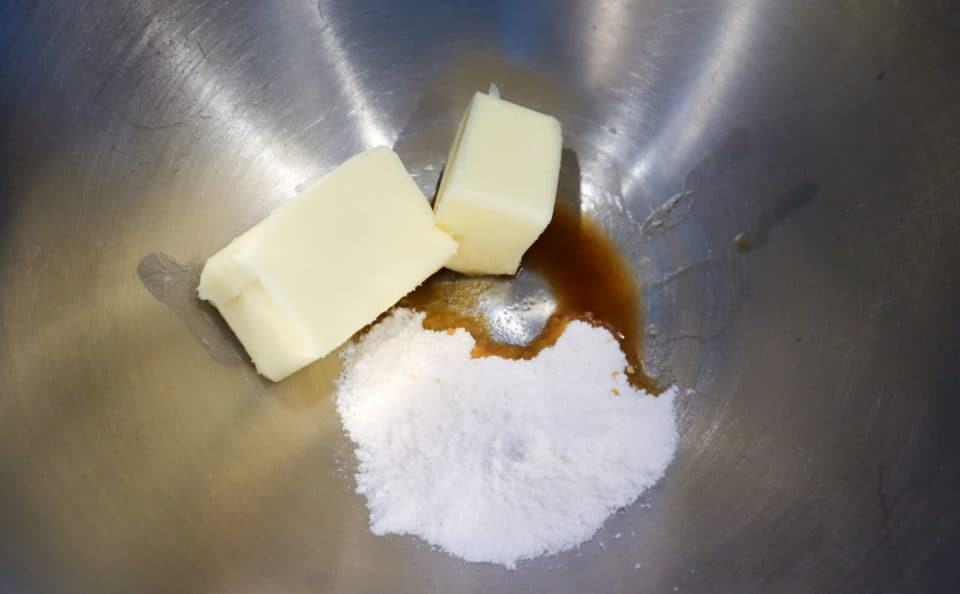 Butter, vanilla and pudding powder in a bowl before mixing.