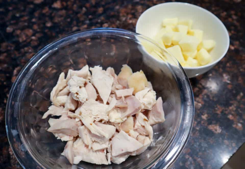 Chopped chicken and chopped brie in small bowls for Creamy Chicken Linguine with Brie.
