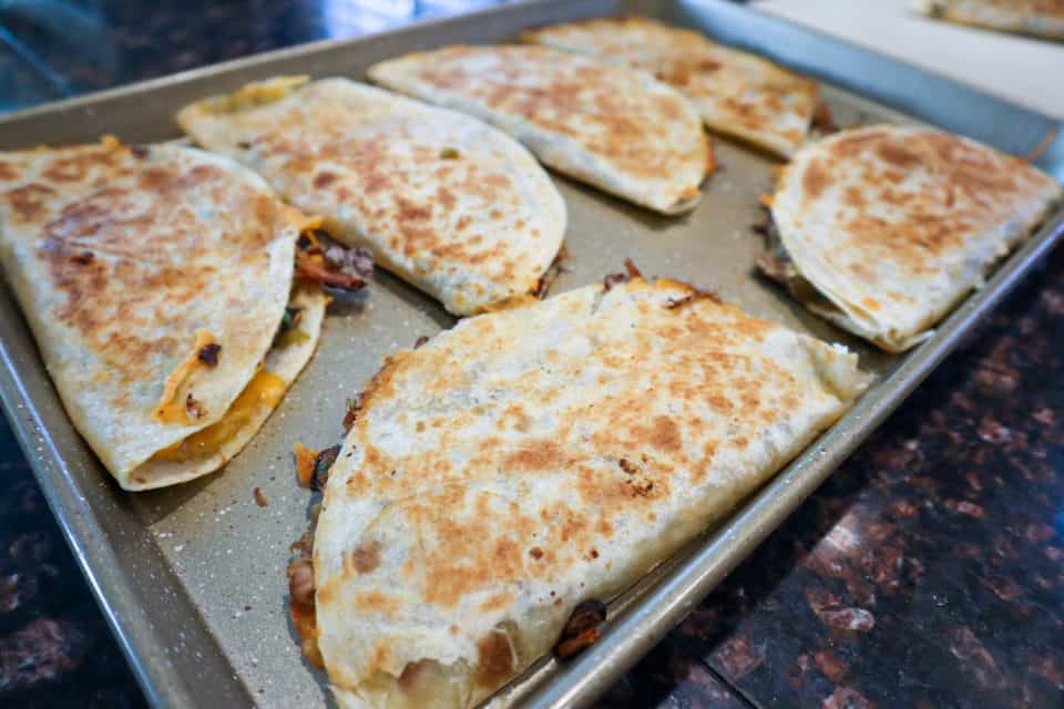 Finished Pulled Pork Quesadillas on a baking sheet.