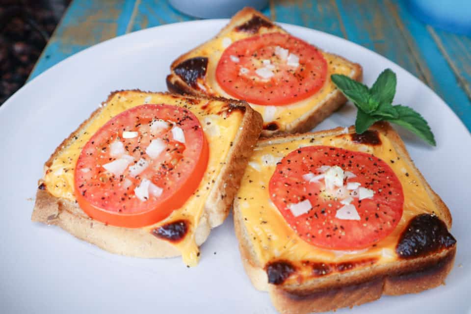 Finished Broiled Tomato Toasties on a plate.