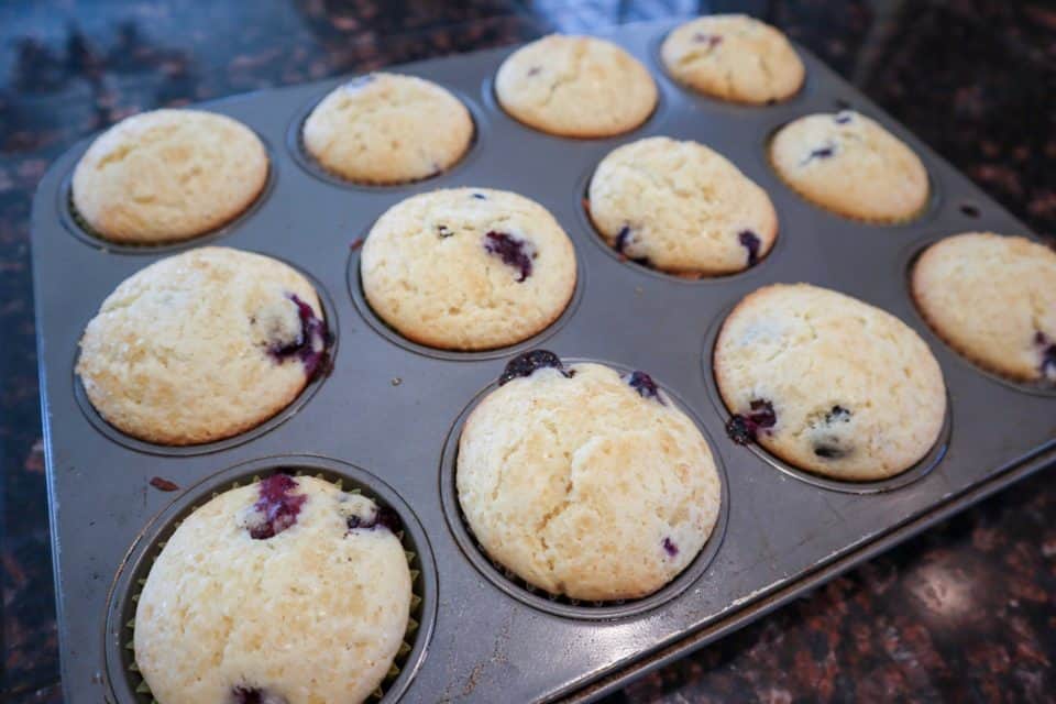 Finished Lemon Blueberry Sunshine Muffins, on a cooling rack.