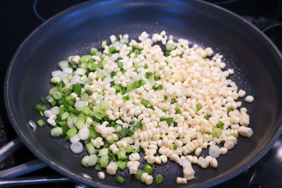 Corn, green onions and jalapenos in the skillet