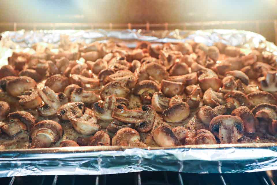 Savory Baked Mushrooms in the oven on a baking sheet